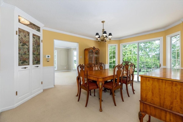 7819 Luin Ln, Windsor Heights, IA 50324 - dining room featuring a chandelier, ornamental molding, and light carpet