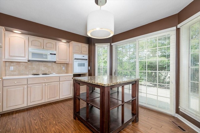 7819 Luin Ln, Windsor Heights, IA 50324 - kitchen featuring white appliances, light countertops, wood finished floors, and backsplash