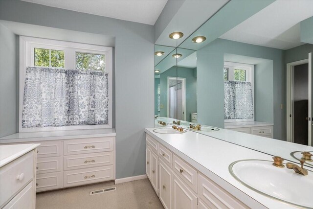7819 Luin Ln, Windsor Heights, IA 50324 - full bathroom with double vanity, healthy amount of natural light, and recessed lighting