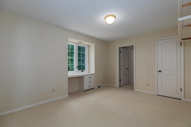 7819 Luin Ln, Windsor Heights, IA 50324 - unfurnished bedroom featuring light colored carpet and an office area