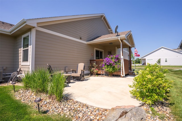 2801 SW Prairie Trail Pkwy, Ankeny, IA 50023 - rear view of property with a patio area, roof with shingles, and a yard