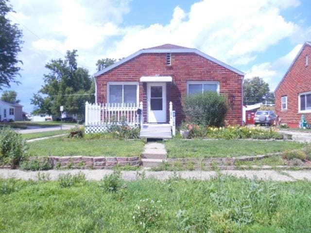 702 Woodbury St, Marshalltown, IA 50158 - bungalow-style house with brick siding