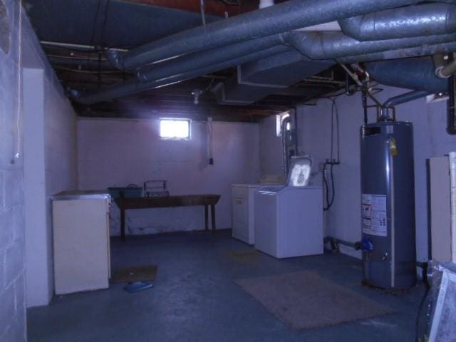 702 Woodbury St, Marshalltown, IA 50158 - below grade area featuring water heater and washer and clothes dryer
