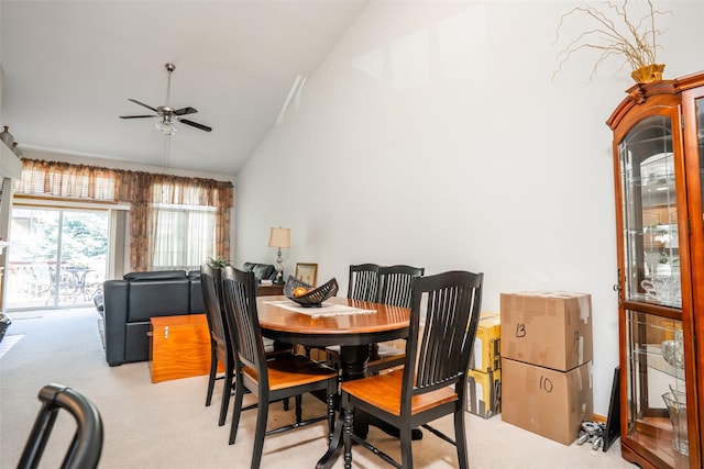 1745 Waters Edge Dr, Pleasant Hill, IA 50327 - dining area with light colored carpet, a ceiling fan, and high vaulted ceiling