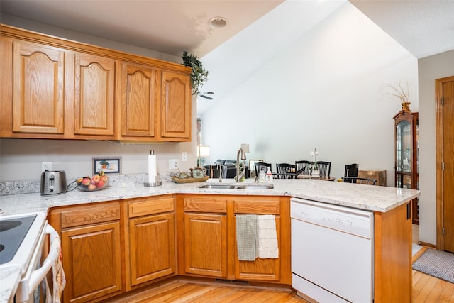 1745 Waters Edge Dr, Pleasant Hill, IA 50327 - kitchen with white appliances, a peninsula, light wood-style flooring, and vaulted ceiling