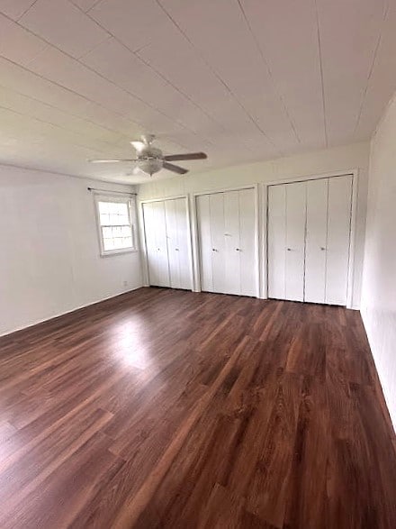 426 N 1st St, Ogden, IA 50212 - unfurnished bedroom featuring multiple closets, wood finished floors, and ceiling fan