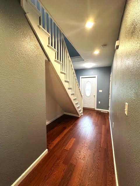 426 N 1st St, Ogden, IA 50212 - foyer entrance featuring wood finished floors, stairway, and a textured wall