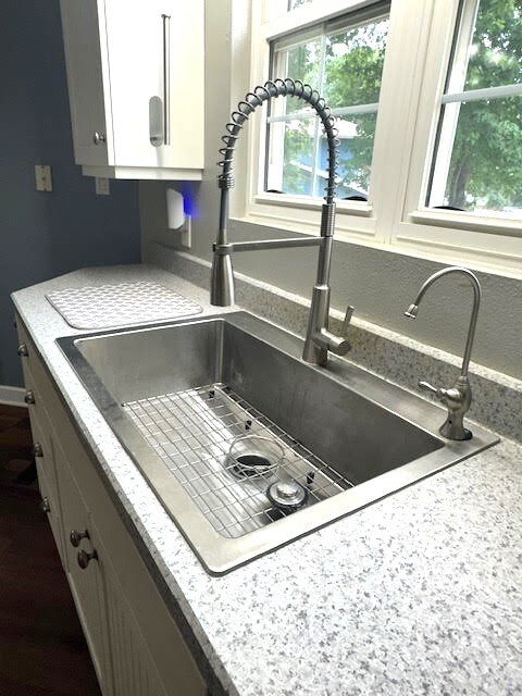 426 N 1st St, Ogden, IA 50212 - kitchen view of white cabinets and light stone countertops