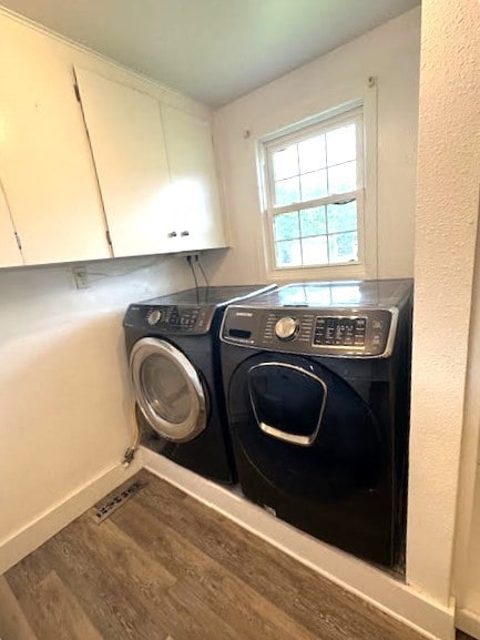 426 N 1st St, Ogden, IA 50212 - laundry room featuring cabinet space, independent washer and dryer, and wood finished floors