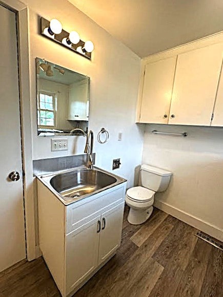 426 N 1st St, Ogden, IA 50212 - bathroom featuring wood finished floors and vanity