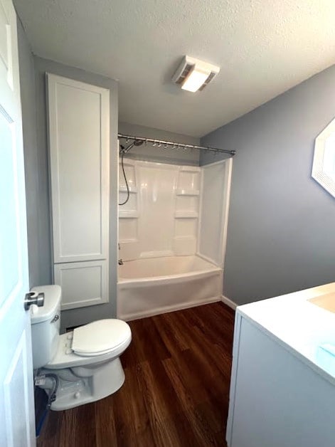 426 N 1st St, Ogden, IA 50212 - bathroom with wood finished floors, vanity,  shower combination, and a textured ceiling