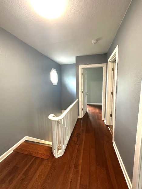 426 N 1st St, Ogden, IA 50212 - hallway with wood finished floors, an upstairs landing, and a textured ceiling