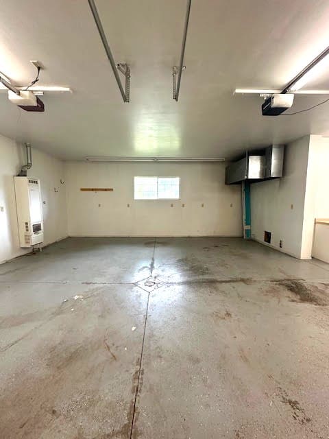 426 N 1st St, Ogden, IA 50212 - garage featuring water heater and a garage door opener