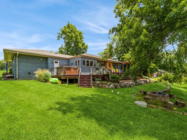 470 Juniper Ave, Kellogg, IA 50135 - back of property featuring a deck and a lawn