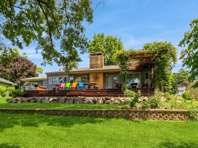 470 Juniper Ave, Kellogg, IA 50135 - back of house with a chimney, a lawn, and a deck