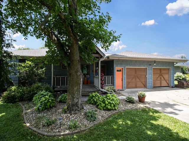 470 Juniper Ave, Kellogg, IA 50135 - ranch-style house with covered porch, concrete driveway, an attached garage, and roof with shingles