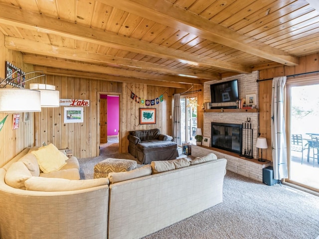 470 Juniper Ave, Kellogg, IA 50135 - carpeted living area featuring wood walls, a wooden ceiling with exposed beams, and a fireplace
