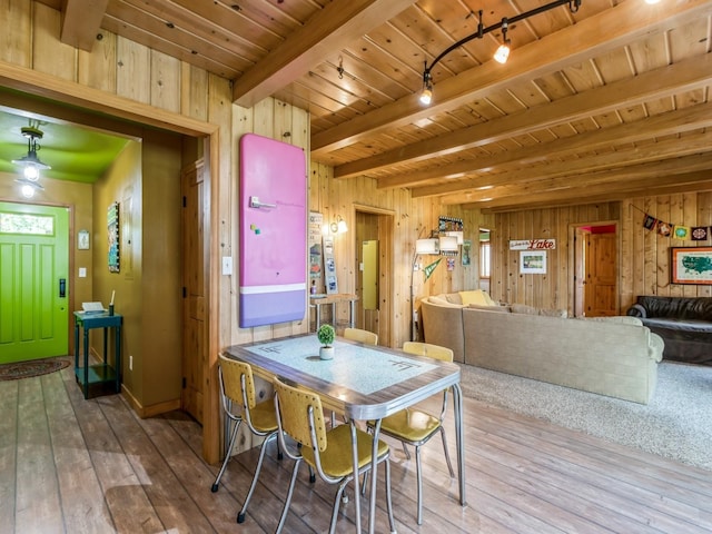 470 Juniper Ave, Kellogg, IA 50135 - dining space with rail lighting, wood walls, hardwood / wood-style floors, and a wood ceiling with exposed beams