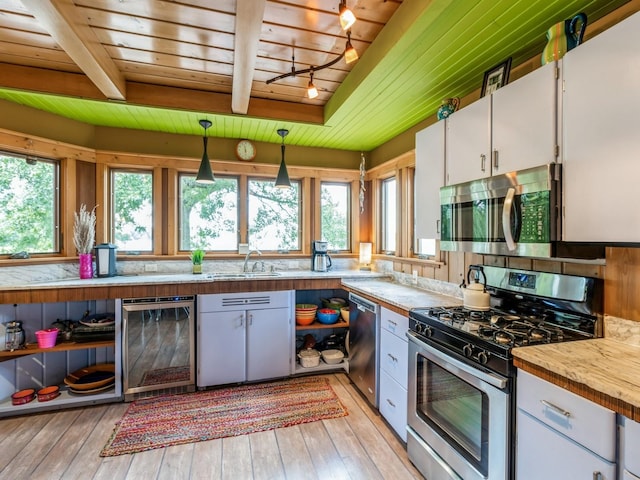 470 Juniper Ave, Kellogg, IA 50135 - kitchen with appliances with stainless steel finishes, beverage cooler, a wood ceiling with exposed beams, white cabinets, and light countertops