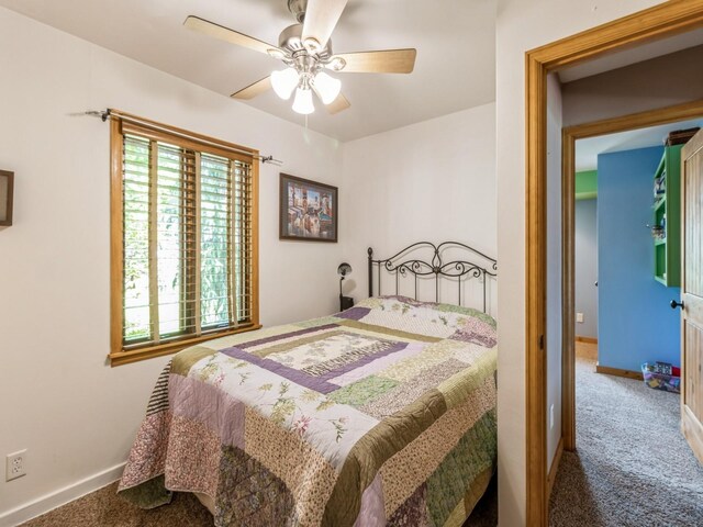 470 Juniper Ave, Kellogg, IA 50135 - carpeted bedroom featuring baseboards and a ceiling fan