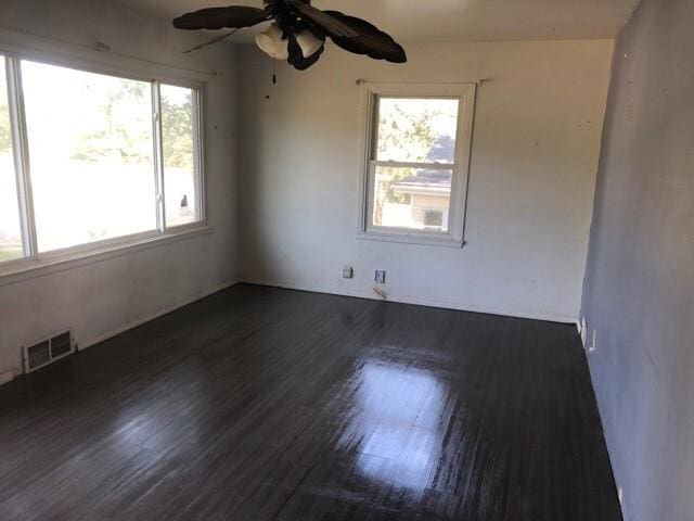 920 Amos Ave, Des Moines, IA 50315 - spare room with a ceiling fan and dark wood finished floors