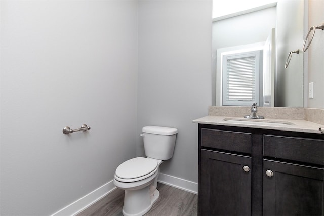 15321 Goldenrod Dr, Urbandale, IA 50323 - half bath featuring vanity and wood finished floors