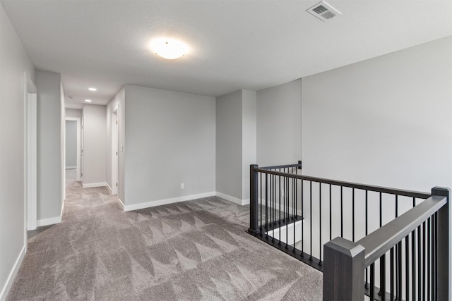 15321 Goldenrod Dr, Urbandale, IA 50323 - hallway with an upstairs landing, carpet, and recessed lighting