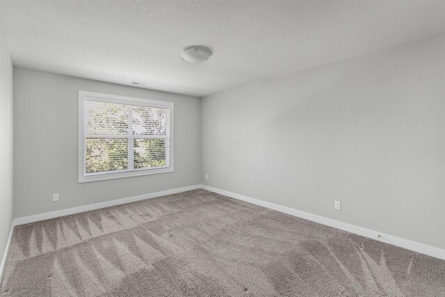 15321 Goldenrod Dr, Urbandale, IA 50323 - carpeted empty room featuring baseboards and a textured ceiling