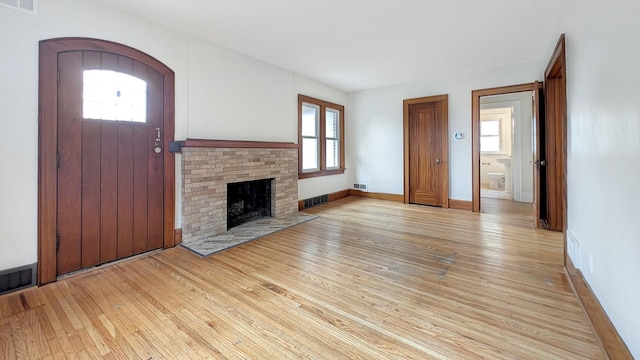 343 58th St, Des Moines, IA 50312 - unfurnished living room featuring light wood finished floors and healthy amount of natural light