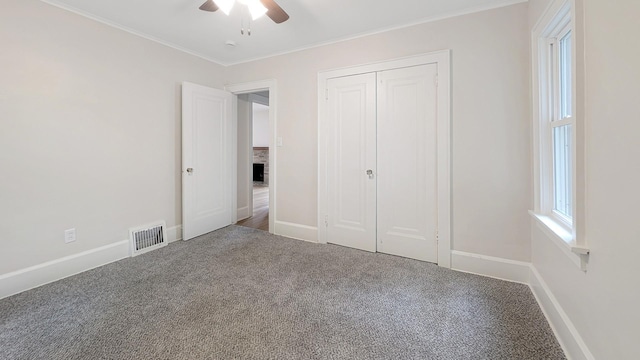 343 58th St, Des Moines, IA 50312 - unfurnished bedroom featuring carpet, ornamental molding, a closet, and ceiling fan