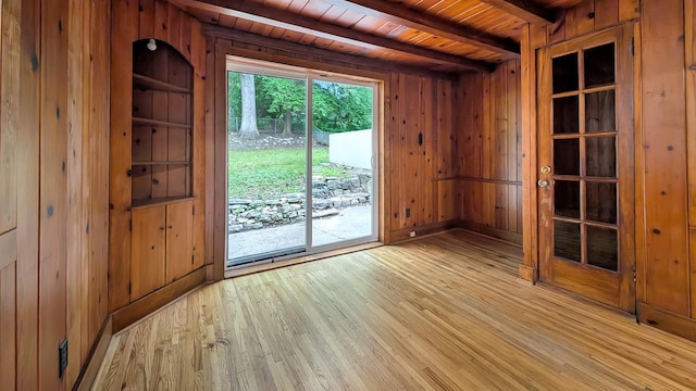 343 58th St, Des Moines, IA 50312 - unfurnished room with wood walls, light wood-style flooring, and a wood ceiling with exposed beams