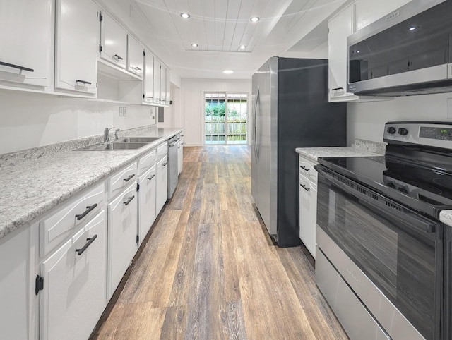 1410 Thomas St, Redfield, IA 50233 - kitchen featuring stainless steel appliances, light wood-type flooring, recessed lighting, and white cabinetry