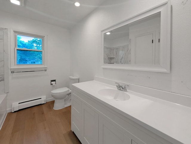 1410 Thomas St, Redfield, IA 50233 - bathroom featuring a baseboard heating unit, vanity, wood finished floors, and recessed lighting