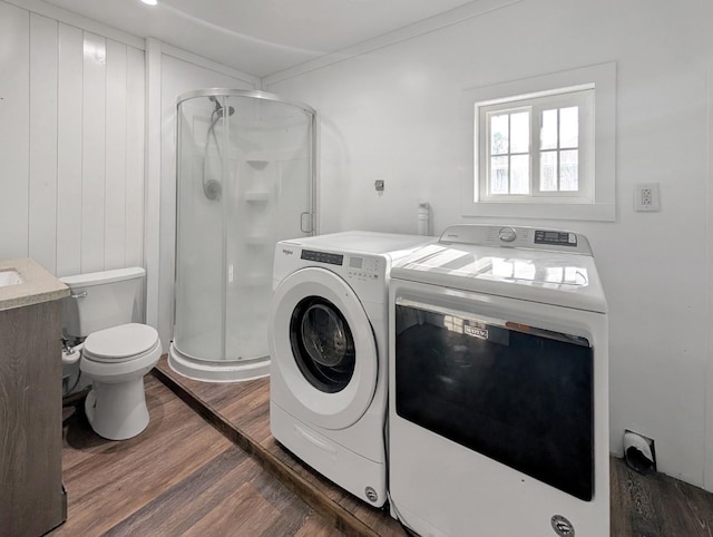1410 Thomas St, Redfield, IA 50233 - laundry room featuring washer and clothes dryer, dark wood finished floors, and ornamental molding