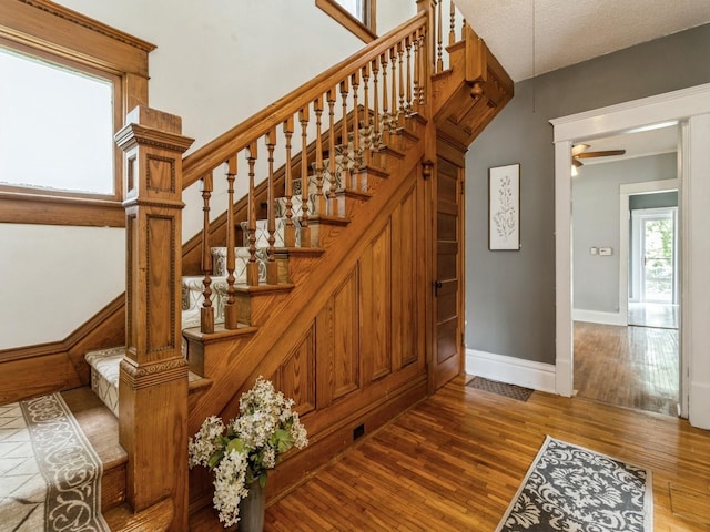 700 W Boston Ave, Indianola, IA 50125 - stairway with wood finished floors and a ceiling fan