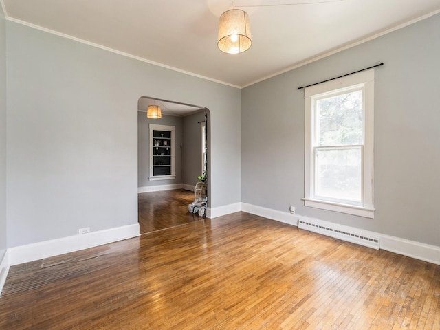 700 W Boston Ave, Indianola, IA 50125 - unfurnished room with arched walkways, a baseboard radiator, hardwood / wood-style flooring, and ornamental molding