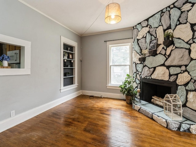 700 W Boston Ave, Indianola, IA 50125 - unfurnished living room with ornamental molding, wood finished floors, and a fireplace