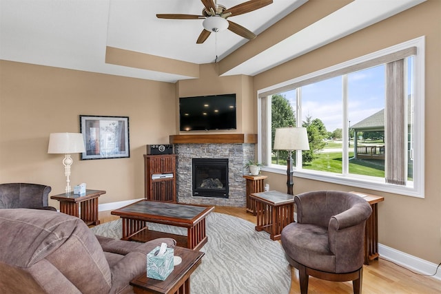 1592 SE Blackthorne Dr, Waukee, IA 50263 - living area with a ceiling fan, a fireplace, and light wood finished floors