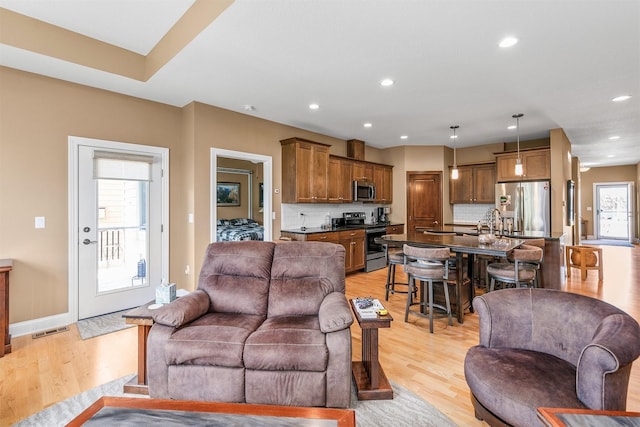 1592 SE Blackthorne Dr, Waukee, IA 50263 - living room featuring light wood-style floors and recessed lighting