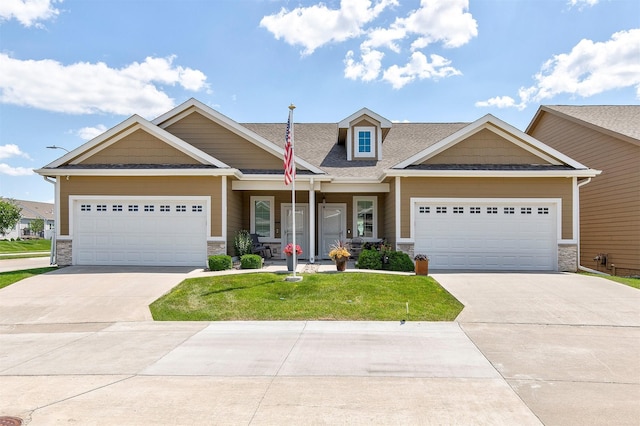 1592 SE Blackthorne Dr, Waukee, IA 50263 - view of front facade featuring concrete driveway, stone siding, and a garage