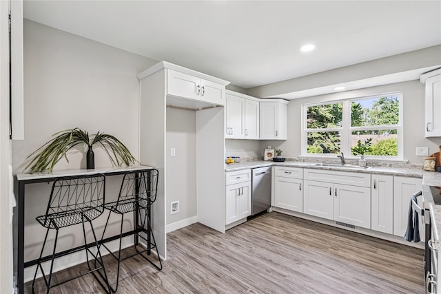 8066 Pilmer Dr, Des Moines, IA 50320 - kitchen featuring dishwasher, white cabinetry, light wood-type flooring, recessed lighting, and light stone counters