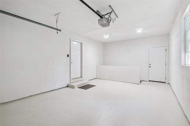 8066 Pilmer Dr, Des Moines, IA 50320 - garage featuring a garage door opener