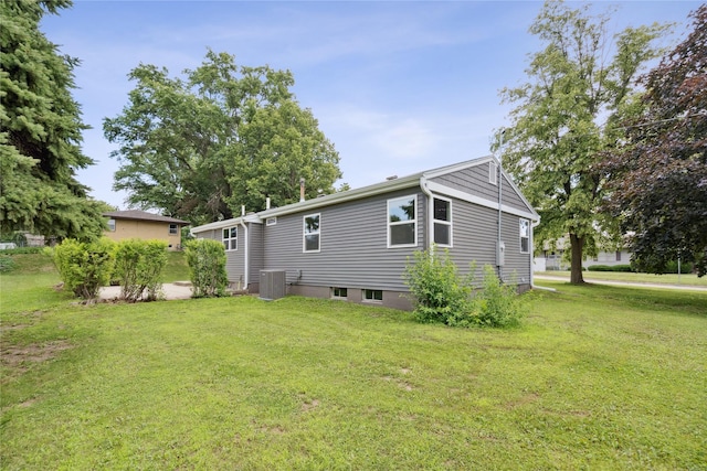 8066 Pilmer Dr, Des Moines, IA 50320 - view of home's exterior featuring a central air condition unit and a lawn