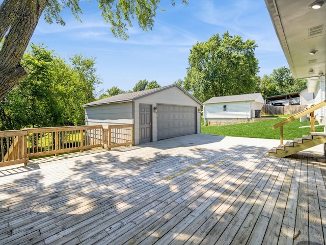 4518 SE 6th St, Des Moines, IA 50315 - deck featuring a detached garage, an outbuilding, and a yard