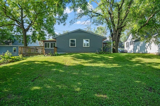 3017 Lincoln Way, Ames, IA 50014 - rear view of property featuring a yard and a wooden deck