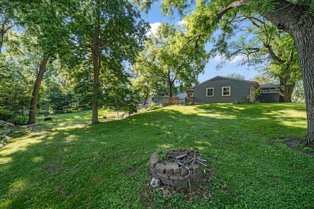 3017 Lincoln Way, Ames, IA 50014 - view of grassy yard with an outdoor fire pit