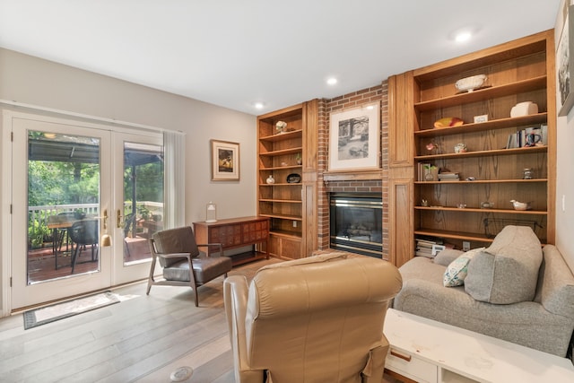 3124 Greenwood Rd, Ames, IA 50014 - living area featuring built in shelves, a fireplace, recessed lighting, wood finished floors, and french doors