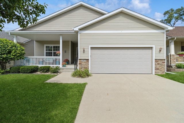 1921 Bristol St, Norwalk, IA 50211 - view of front of home featuring an attached garage, a porch, driveway, and a front lawn