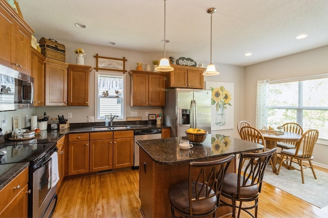 1921 Bristol St, Norwalk, IA 50211 - kitchen with appliances with stainless steel finishes, healthy amount of natural light, light wood-style floors, and recessed lighting