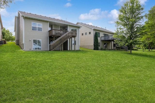 1921 Bristol St, Norwalk, IA 50211 - rear view of property with a wooden deck, a yard, and stairs